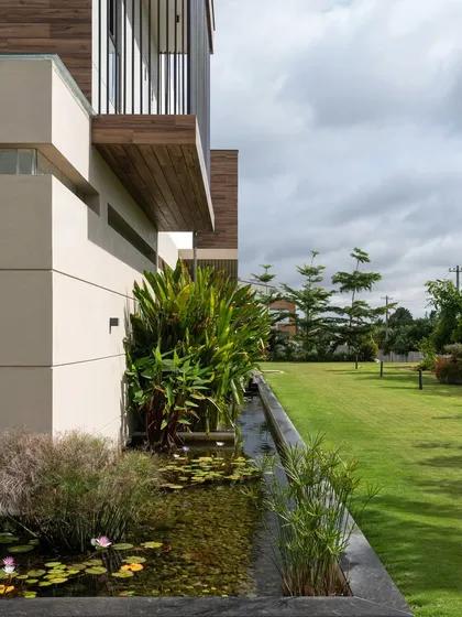 The Celadon residence, a quiet retreat nestled within a one-acre farm. Here, our design blur the line between architecture and landscape, with a tranquil koi pond and lush plantings that wrap around the home, integrating it seamlessly into its natural surroundings.