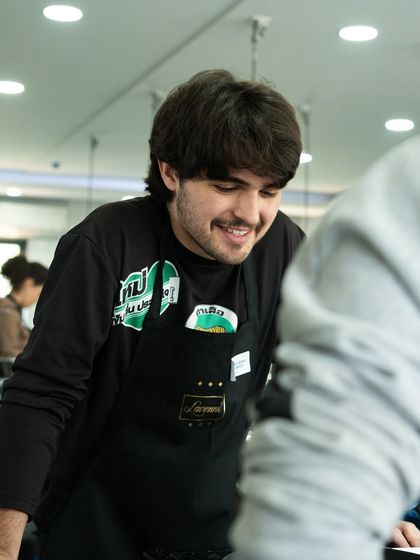 The joy of learning. A smiling student from UNISG engages with our chefs during the Indian breads workshop.