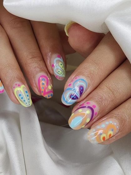 This psychedelic-inspired nail art features layers of colorful dots and swirls. It's a complex, hand-painted design for a truly one-of-a-kind look.