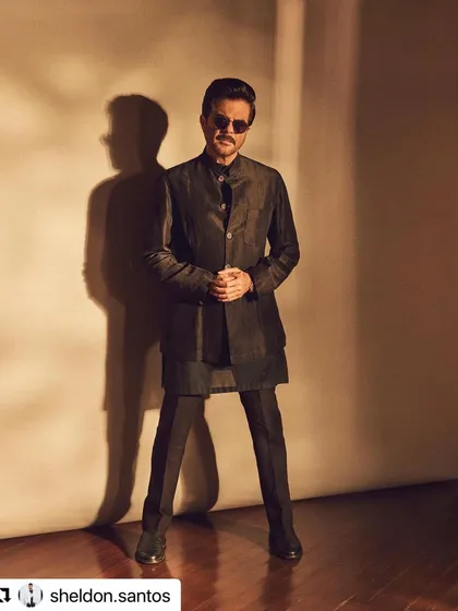 A full-body shot showing how the classic hairstyle complements the traditional yet modern outfit.