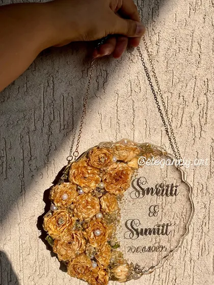 Another angle of the beautiful wall-hanging frame, showing how the light catches the preserved yellow roses and the elegant script of the couple's names.