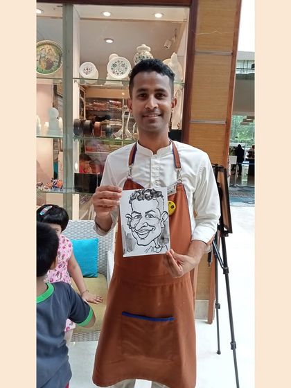 A member of the hotel staff took a moment to get his caricature done. It's fun for everyone, including the hosts.