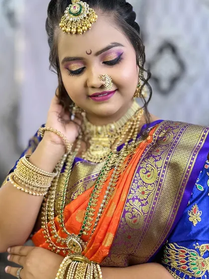 A close-up of the eye makeup, featuring a blend of gold and purple with a sharp wing, a popular bridal style.