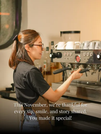 This November, we're thankful for every sip, smile, and story shared. A shot of our barista at the espresso machine, crafting drinks with care.