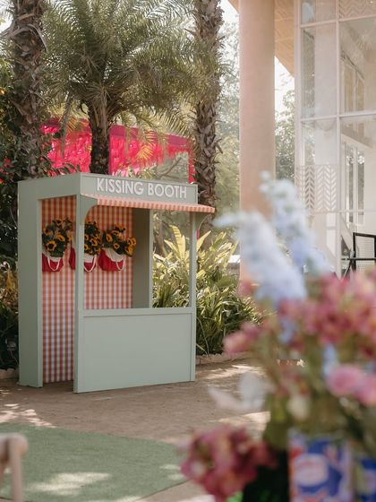 A whimsical kissing booth, adding a playful and photo-friendly element to the fun-filled Mehendi carnival.