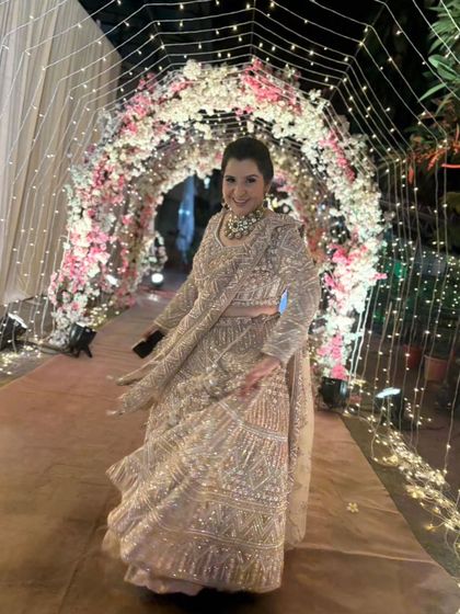 Our client is shining in this heavily embellished beige lehenga. It's a glamorous and sophisticated choice for a wedding reception.