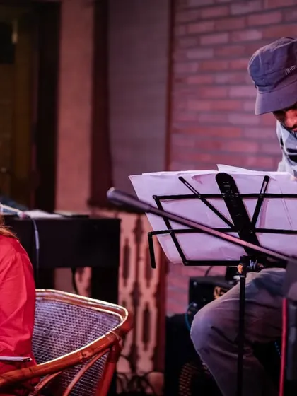 A shot of the REFUGE ensemble, featuring Apoorva Krishna on violin and Dhani Muniz on fretless bass, as they perform their unique blend of jazz and Indian classical music.