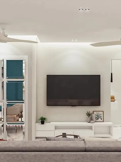 This concept showcases a completely integrated storage solution. The minimalist white TV unit is flanked by custom cabinetry, including a mirrored bar unit and a dedicated pooja (prayer) unit, demonstrating how I tailor designs to a client's specific needs.