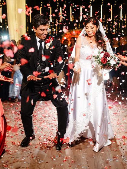 The couple's grand entrance, dancing their way into the reception under a shower of heart-shaped confetti.