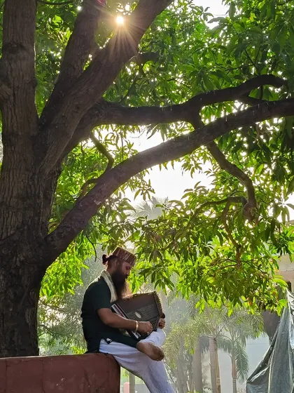 Finding a moment of peace under a tree, with my harmonium. Nature is the greatest temple, and music is a beautiful prayer to offer in its sacred space.