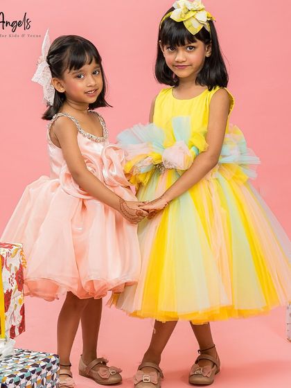 A sweet moment between two friends in our colorful party dresses.