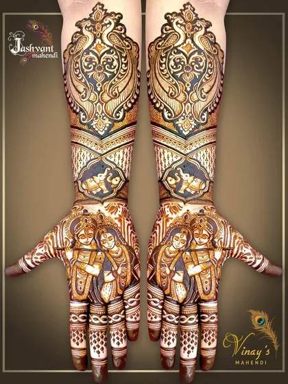 A complete bridal look featuring symmetrical Radha Krishna portraits on both palms. The design extends up the arms with matching peacock and elephant motifs for a cohesive and divine theme.