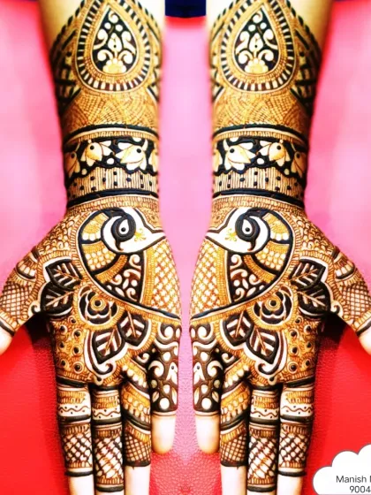 Symmetrical peacock designs are a classic choice for bridal mehndi. Here, the peacocks face each other across the palms, surrounded by detailed check patterns and floral work that extends up the arm.