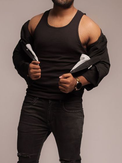 A close-up shot focusing on the torso and styling. This image shows how to create a powerful look even when fully clothed, hinting at the physique underneath.