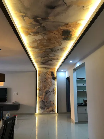 This wide shot captures how the ceiling feature defines the entire open-plan living and dining area, creating a luxurious and cohesive space.