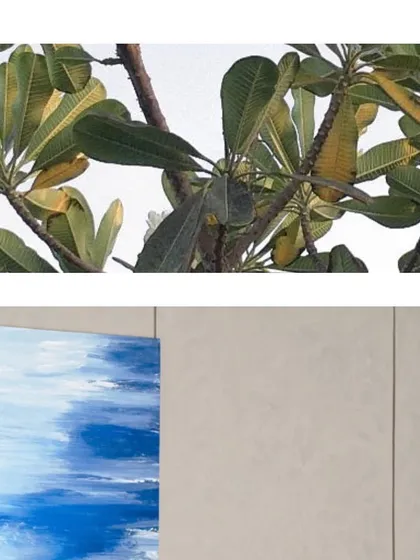 A close-up of the textures that inspire us. The natural pattern of leaves against a textured wall and a painted canvas shows how we find beauty in the layers around us.