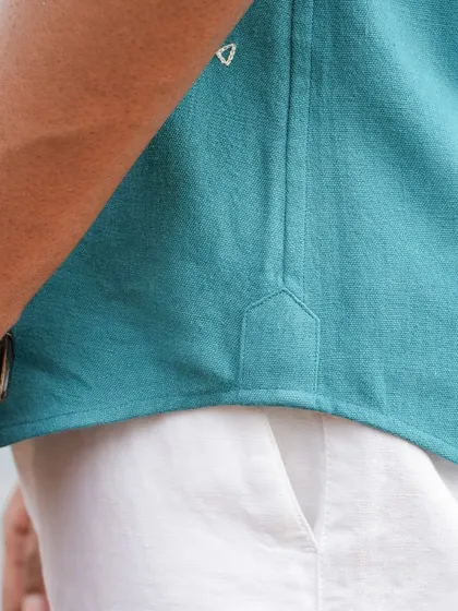 A detail shot of the side gusset on our panther-motif shirt, showcasing the quality construction and fine fabric.