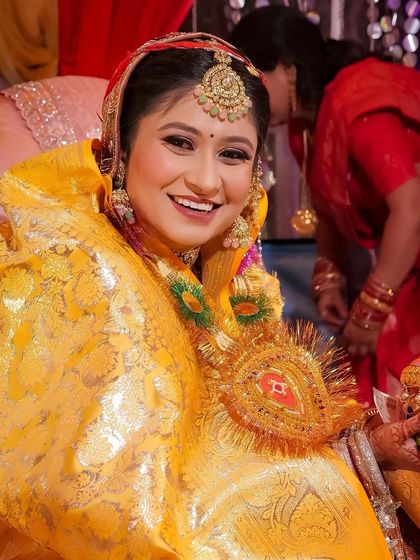 The beautiful smile of a happy bride. Her yellow outfit for this pre-wedding ceremony is so bright and joyful.