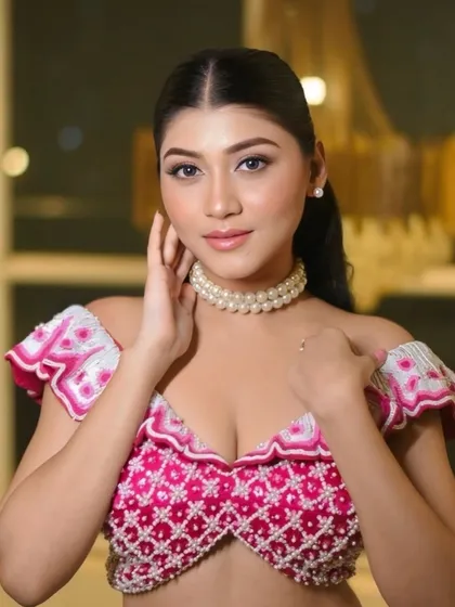A confident and glamorous pose. The makeup enhances her features, with a focus on luminous skin and beautifully defined eyes.
