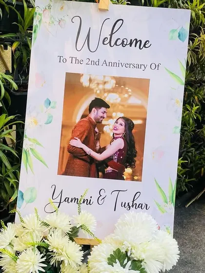 A personalized welcome sign for an anniversary party. This easel stand features a custom print with the couple's photo, welcoming guests to their 2nd-anniversary celebration.