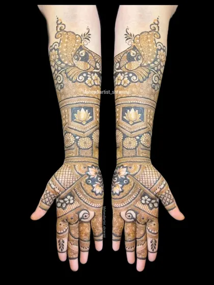 A full view of a classic bridal design combining popular motifs. The forearms feature prominent peacocks, while the palms have a floral and geometric pattern.
