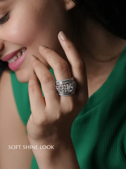 A "soft shine" look captured perfectly. This wide, multi-layered diamond ring combines different cuts and settings to create a piece with incredible texture and sparkle. It’s a substantial yet elegant ring that feels both powerful and personal.