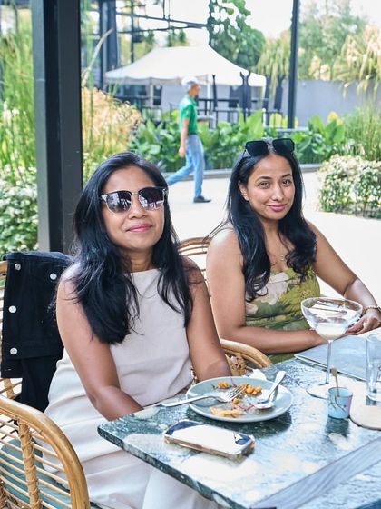 Two friends enjoying a meal and conversation in our beautiful outdoor seating area.