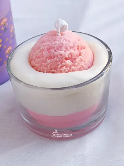 A front-facing view of the pink ice cream scoop dessert candle.