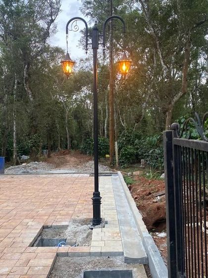 A close-up of one of the lamp posts and the detailed iron gate at the Sakleshpur site.