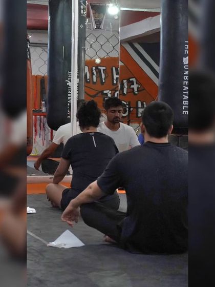 A coach leads a guided meditation. These sessions are part of our holistic approach to training, ensuring mental wellness is as much a priority as physical fitness.