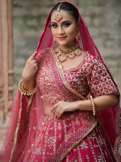 A full view of the bride in her pink lehenga, looking graceful and elegant.