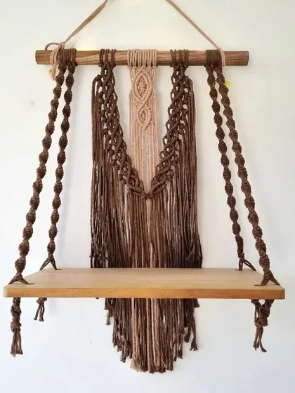 This intricately woven macrame shelf adds a touch of bohemian charm to any room. It's perfect for displaying your favorite small plants, books, or treasures.