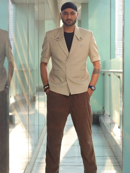A full-length view of Harbhajan Singh in our custom short-sleeved beige blazer, a unique and stylish take on formalwear.