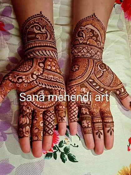 This design is filled with traditional animals, including peacocks on the wrist and rows of tiny elephants on the fingers.