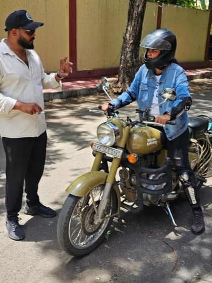 Getting comfortable on the bike with a helmet on is a key step. I guide a student as she gets used to the feel and weight of the motorcycle in full safety gear.