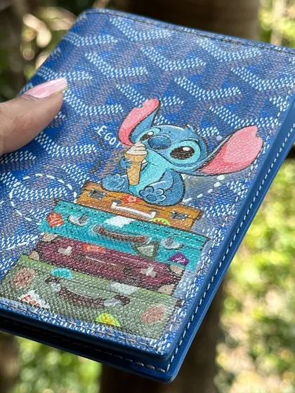 It's not just about sneakers. I love getting to paint on different things, like this Goyard passport cover. The challenge was to paint a super cute Stitch on the textured canvas, complete with tiny travel bags. It’s the perfect accessory for your next adventure.