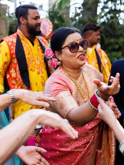 The mother of the groom, looking cool in her sunglasses, joins the dance party. I love capturing the joy of the whole family during the baraat.