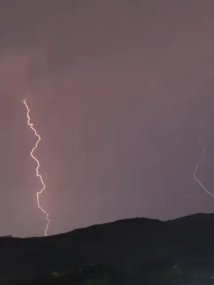 This shot captures the storm as it moved over the hills. I used a long exposure to capture these distinct, powerful bolts of lightning as they lit up the night.