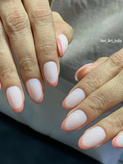 Another angle of the simple and clean peach-colored French tips, showing how they flatter the nail shape.