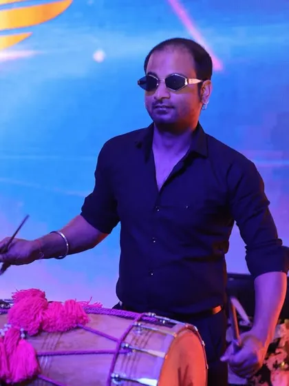The heart of our Punjabi beats. Our dhol player isn't just playing an instrument; he's bringing an authentic, powerful rhythm that is essential for any big fat Indian wedding celebration.