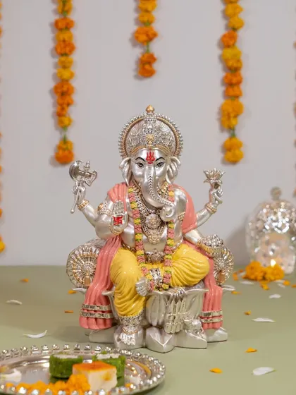 This beautifully colored Ganesh idol, with its gentle pink and yellow hues, brings a soft and peaceful energy. It is a wonderful piece for adding a touch of modern devotion to your festive decorations.