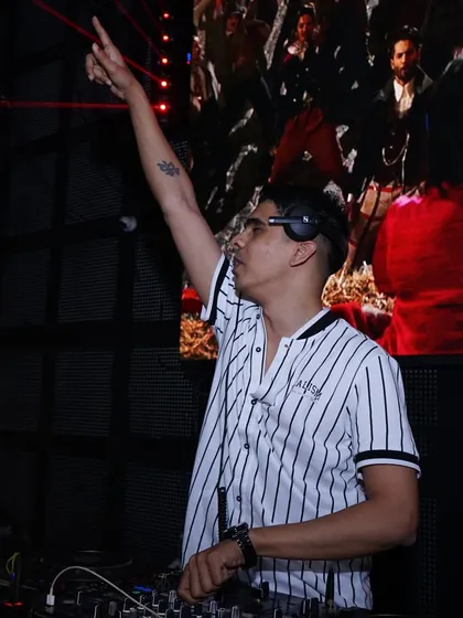 Pointing to the sky, feeling the energy of the party capital.