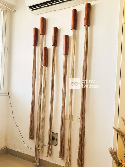 A full view of the installed wall art. The varying lengths and tones of the jute create a sense of movement and depth, making it a dynamic focal point for any room.