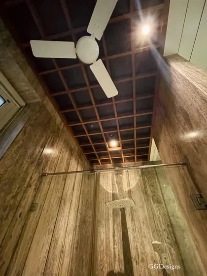 High ceilings can make even a smaller space like a bathroom feel grand and airy. Here, I used a wooden grid on the ceiling to add warmth and architectural interest, while also allowing for integrated lighting.