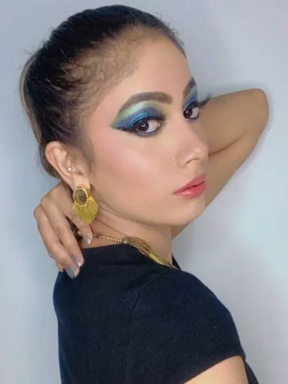 A closer look at the glamour fashion makeup. You can see the blend of the blue and green eyeshadows and the sharp liner, creating a powerful and captivating gaze perfect for a portfolio.