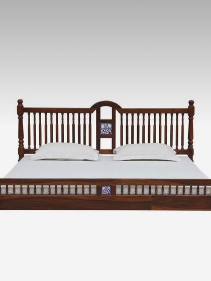 A frontal view of the classic wooden bed, showing the symmetry of the headboard and footboard design. We build our furniture to be solid and durable, ensuring it lasts for generations.