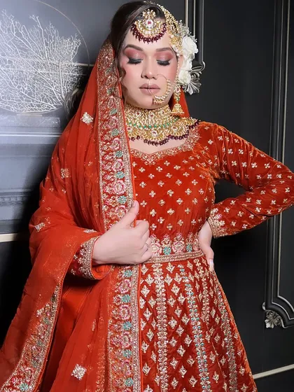 An extensive series from a bridal demo, showcasing a red velvet Anarkali-style lehenga. This is a valuable resource for MUAs learning to create a classic bridal look.