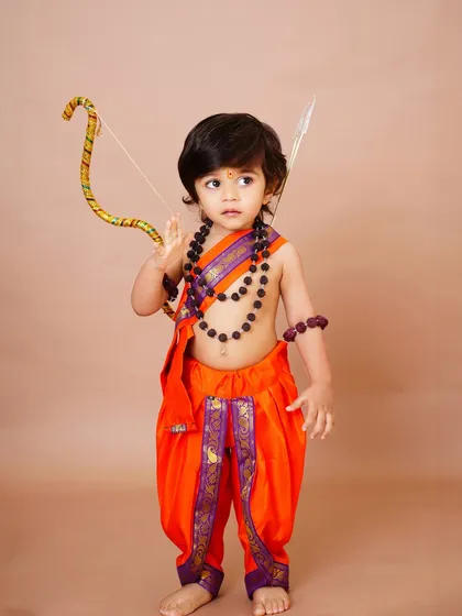 A little boy dressed as Lord Rama for a Ram Navami themed shoot, holding a bow and arrow. I love bringing these creative cultural ideas to life.