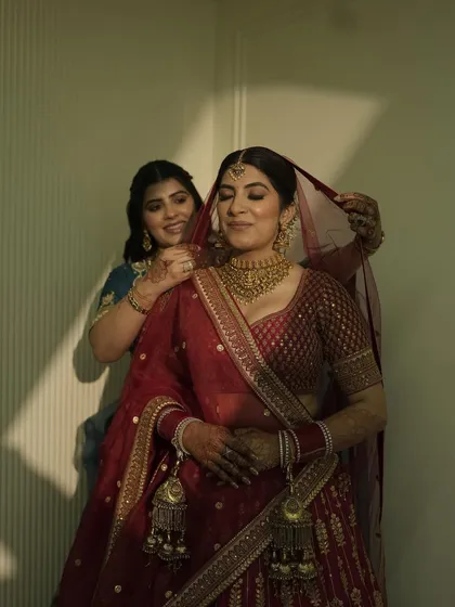 A precious moment of me helping my sister with her veil. Creating her bridal look was an emotional and beautiful experience, ensuring every detail was perfect for her.
