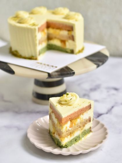 Our Pistachio, Saffron, and Orange cake is a tribute to the flavours of India. With layers of pistachio sponge, orange marmalade, and saffron-infused cream, it's a colourful and joyful cake perfect for any celebration.